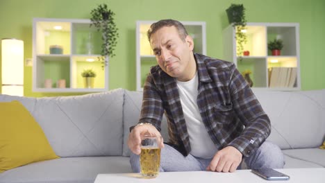 Unhappy-and-sad-man-drinking-alcohol-at-home.